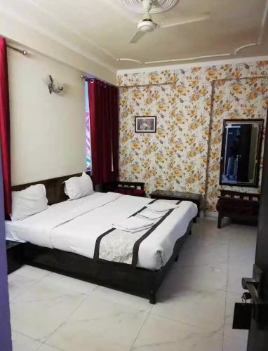 a bedroom with a bed and a tv in it at HOTEL SKY HEIGHTS PALACE in Jaipur