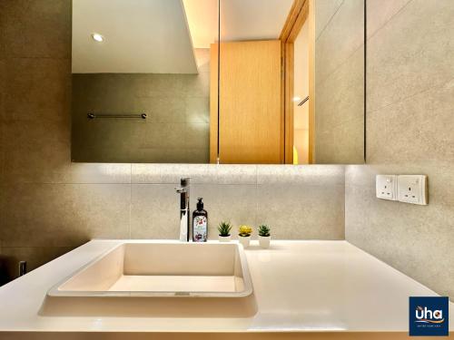a white sink in a bathroom with a mirror at PineTree Puteri Harbour by RR JBcity in Nusajaya