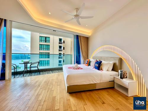 a bedroom with a large bed and a balcony at PineTree Puteri Harbour @ UHA in Nusajaya