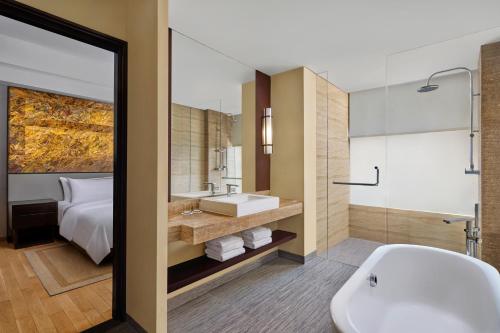 a bathroom with a tub and a sink and a shower at The Westin Resort Nusa Dua, Bali in Nusa Dua