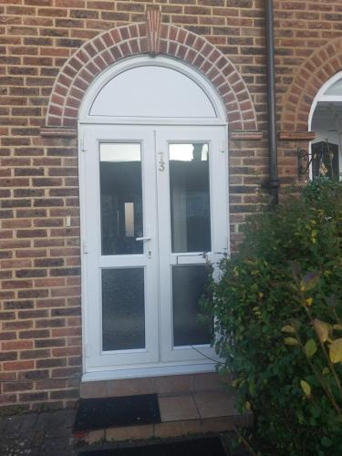 an arched entry door to a brick building at Catford Homely Home in Hither Green