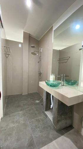 a bathroom with a sink and a mirror at Pier26 Bali Homestay in Nusa Dua