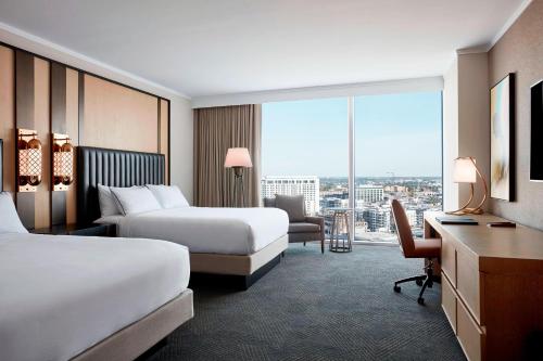 a hotel room with two beds and a desk at JW Marriott Nashville in Nashville