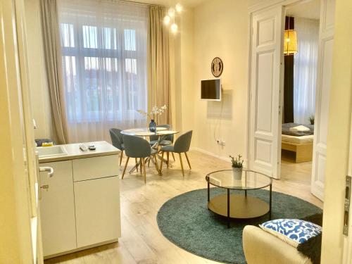 a living room with a table and a dining room at 157m2 Luxury Giant Apartment Complex with 4 Free Garages in Budapest