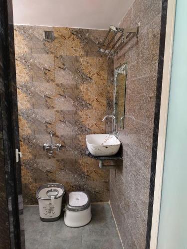 a bathroom with a sink and a toilet at Jawai Rock Hotel in Sheoganj