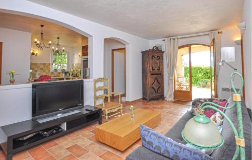 a living room with a couch and a tv at 1 Bedroom Stunning Apartment In Grasse in Grasse