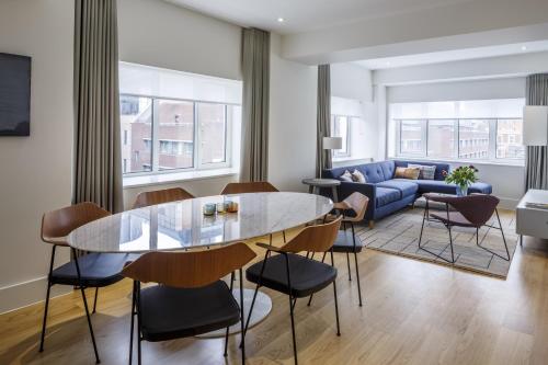 a living room with a table and chairs and a couch at Native Tower Bridge in London