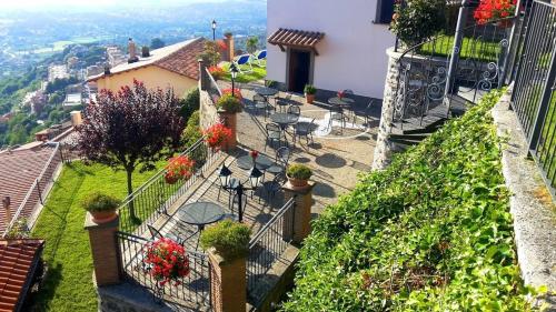 a balcony of a house with tables and chairs at Villa dei Fantasmi in Rocca di Papa