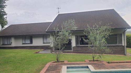 a house with a swimming pool in front of it at Secret guest house in Pietermaritzburg