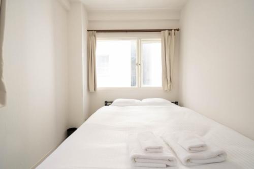 Ένα ή περισσότερα κρεβάτια σε δωμάτιο στο world inn Susukino