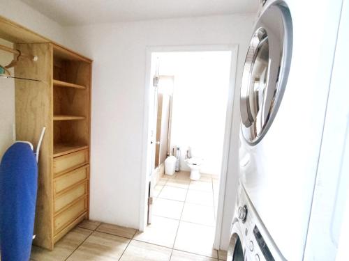 a laundry room with a washer and dryer at Golden sunset 2 in Popotla