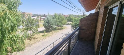 a balcony of a house with a view of a street at Complejo Boulevard Plottier in Plottier