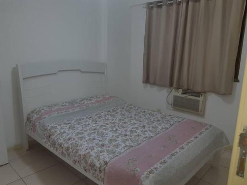 a small bed in a room with a window at Apartamento in Rio de Janeiro