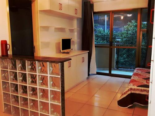 a kitchen with a counter with a computer on it at Apartamento in Rio de Janeiro