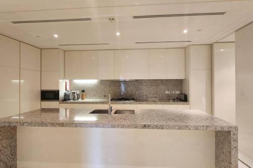 a kitchen with a sink and a counter top at Palazzo Versace - Blue Ocean Holiday Homes in Dubai