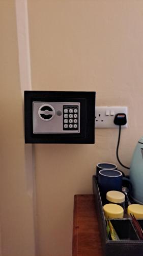 a microwave on a wall next to a table at Emerald Palm Boutique Hotel in Zanzibar City