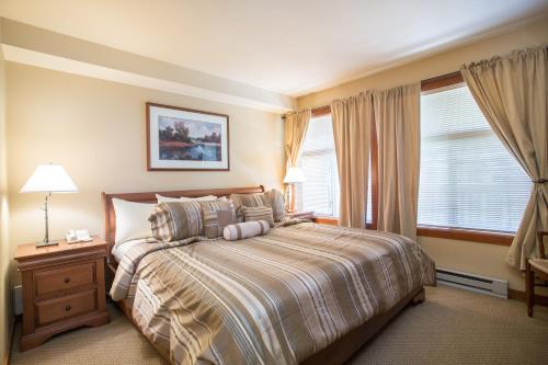 a bedroom with a large bed and a window at 3406 - One Bedroom Den Standard Powderhorn Lodge condo in Solitude