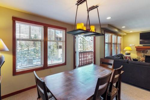 a dining room with a table and a couch at 2307- Two Bedroom Den Deluxe Eagle Springs East Hotel Room in Solitude