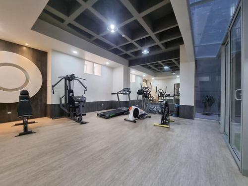 a gym with many exercise equipment in a room at Apartaestudio Carnaval in Barranquilla