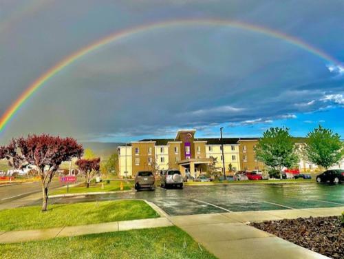 a rainbow over a parking lot with cars parked at La Quinta Inn & Suites by Wyndham Wenatchee in Wenatchee