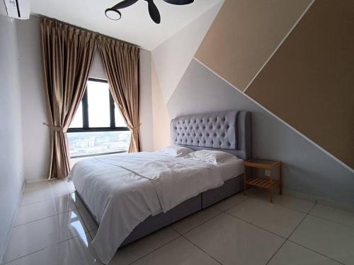 a bedroom with a large bed and a window at The Horizon Ipoh 3BR L16 by Grab A Stay in Ipoh