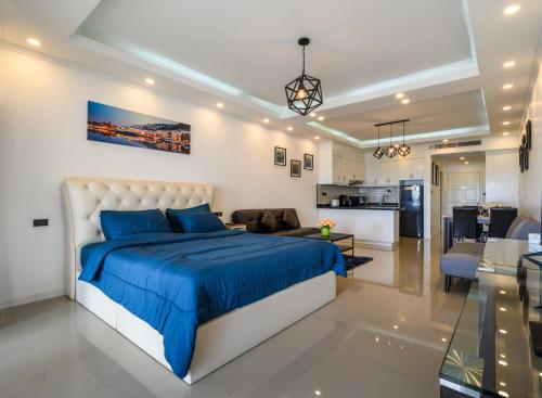 a bedroom with a king sized bed and a living room at Jomtien Beachfront Stylish Studio , Stunning Seaview , Big Pool in Jomtien Beach