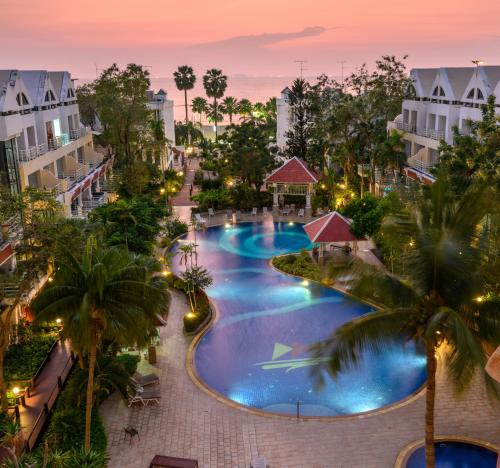 an aerial view of a resort pool at dusk at Jomtien Beachfront Stylish Studio , Stunning Seaview , Big Pool in Jomtien Beach