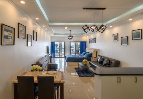 a living room with a couch and a table at Jomtien Beachfront Stylish Studio , Stunning Seaview , Big Pool in Jomtien Beach