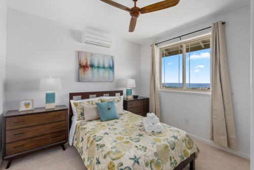 a bedroom with a bed and a window with the ocean at @Marbella Lane-Pōmaika'i LoveNest Ocean+MT View in Waianae
