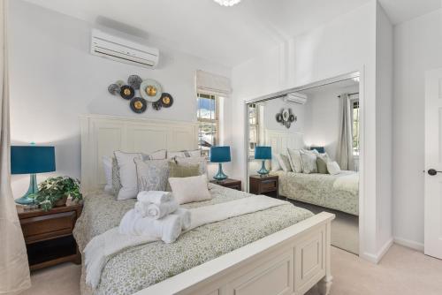 a bedroom with two beds and a large mirror at @Marbella Lane-Pōmaika'i LoveNest Ocean+MT View in Waianae