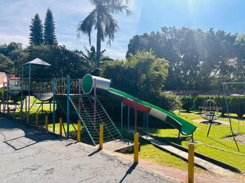 a playground with a slide in a park at Club Santa Maria in Cuernavaca