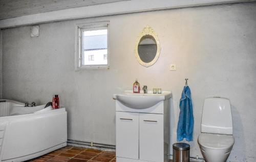 a bathroom with a sink and a toilet and a mirror at 1 Bedroom Beautiful Home In Glemmingebro in Löderup
