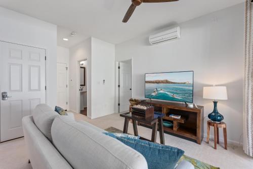 a living room with a couch and a table at @Marbella Lane-Pōmaika'i LoveNest Ocean+MT View in Waianae