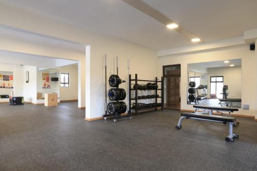 a large room with a gym with weights at Cosyplace at Mi Vida in Garden city in Nairobi