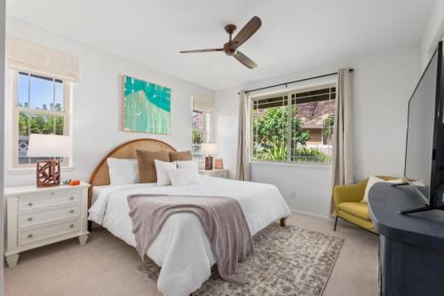 a white bedroom with a bed and a window at @Marbella Lane-Pōmaika'i LoveNest Ocean+MT View in Waianae