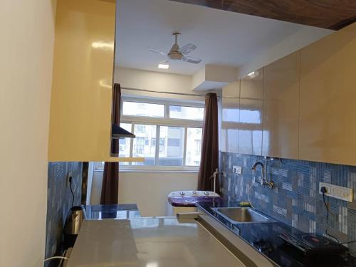 a kitchen with a sink and a window at Luxury Furnish Studio Apt 623 in DLF Moti Nagar Delhi in New Delhi