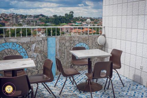 a table and chairs on a balcony with a view at Empire du Luxe in Yaoundé