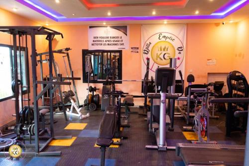 a gym with several tread machines in a room at Empire du Luxe in Yaoundé