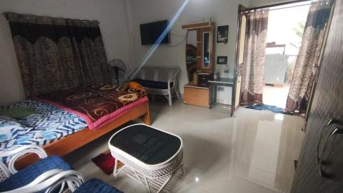 a small bedroom with a bed and a window at House of Rabindra Kumar in Deoghar