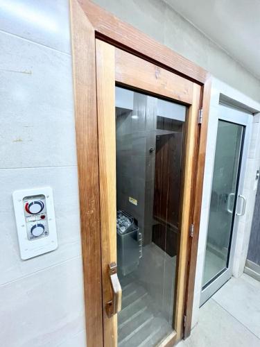 a wooden door with a glass window in a room at Golden sunset 2 in Popotla