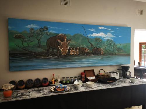 een schilderij van een groep dieren aan een muur bij Parkers Cottages in St Lucia