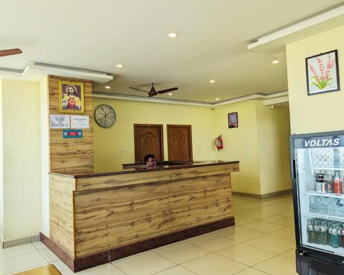 a person sitting at a counter in a restaurant at Hotel Prakash Residency with EV Station in Tiruchchirāppalli