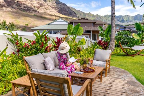 a little girl sitting on a couch on a table at @Marbella Lane-Pōmaika'i LoveNest Ocean+MT View in Waianae