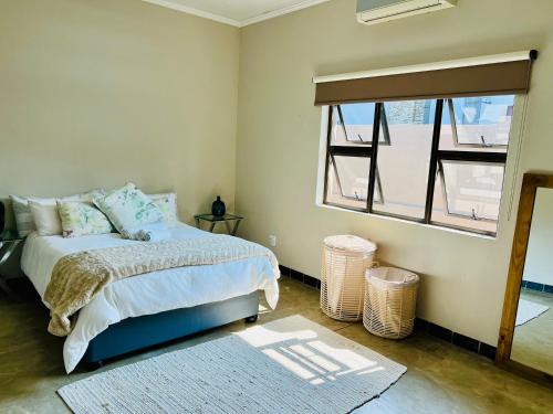 um quarto com uma cama e uma janela em Luxury@Groendal close em Nelspruit