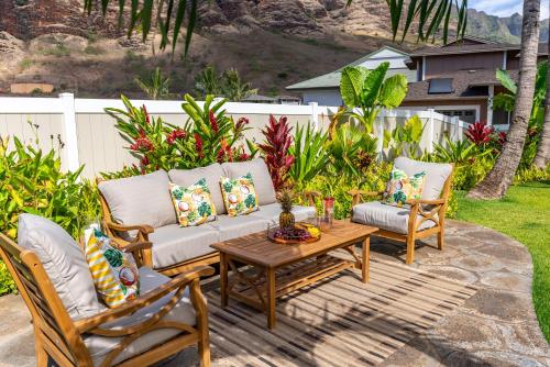 a patio with two chairs and a coffee table at @Marbella Lane-Pōmaika'i LoveNest Ocean+MT View in Waianae