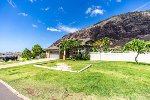 a house with a mountain in the background at @Marbella Lane-Pōmaika'i LoveNest Ocean+MT View in Waianae