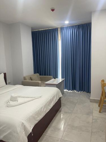 Ένα ή περισσότερα κρεβάτια σε δωμάτιο στο Residence 110 (Hotel and Apartments)