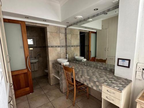 a bathroom with two sinks and a large mirror at Jane's Guesthouse in Saldanha