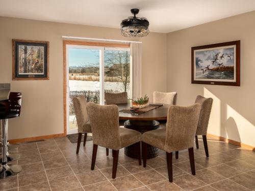 a dining room with a table and chairs and a window at Mountain View Home on 2 Acres in Bozeman