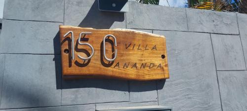 a wooden sign on the side of a wall at Villa Ananda in Cilaos